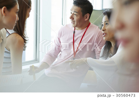 Colleagues sharing idea in business plan together Colleagues sharing idea in business plan together 30560473