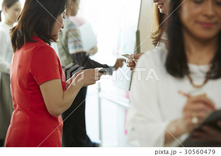 A photo of a woman with a red dress reading something 30560479