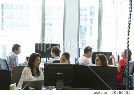 An office with seven staff working in groups An office with seven staff working in groups 30560483