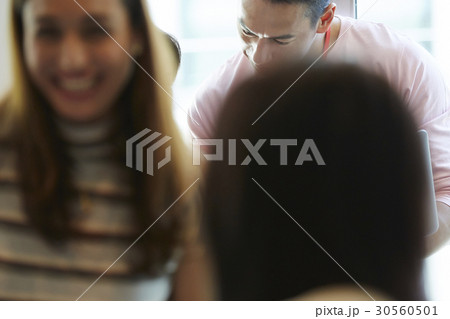 A man is looking down and a woman is smiling 30560501