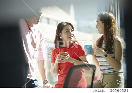 Colleagues enjoy coffee in teatime together Colleagues enjoy coffee in teatime together 30560521