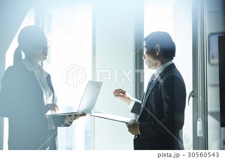 A discussion of two people in office 30560543