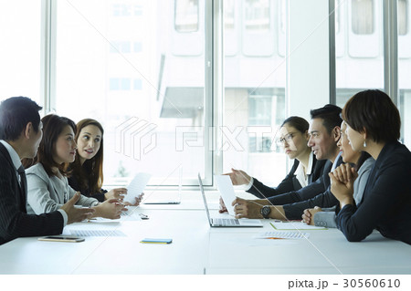 The colleagues are discussing at a meeting in office. The colleagues are discussing at a meeting in office. 30560610