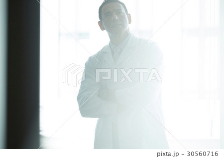 a portrait of a man standing and folding his arms a portrait of a man standing and folding his arms 30560716
