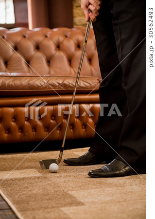 Man playing golf at home 30562493