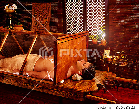 Man having Ayurvedic sauna treatment. Indian 30563823