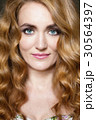 Beautiful young woman with long red curvy hair 30564397