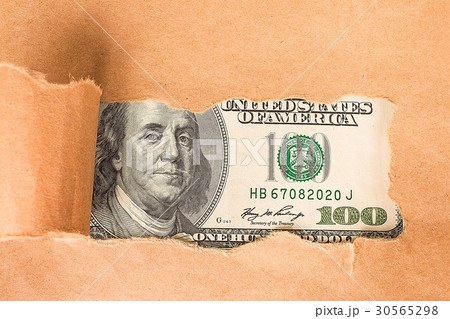 Benjamin Franklin macro through torn paper 30565298