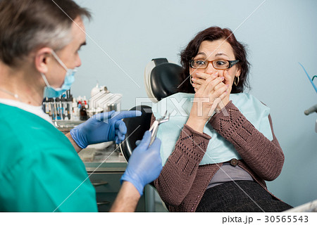 Woman feeling toothache at dental clinic 30565543