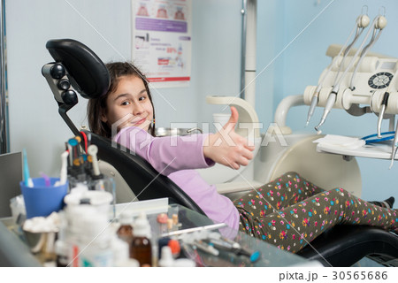 Patient girl at dental clinic office. Medicine 30565686