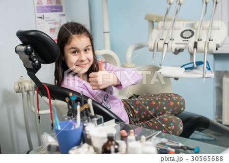 Patient girl at dental clinic office. Medicine 30565688