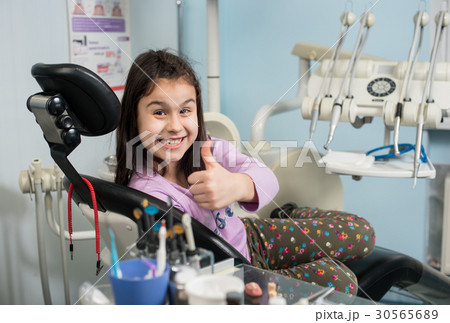 Patient girl at dental clinic office. Medicine 30565689