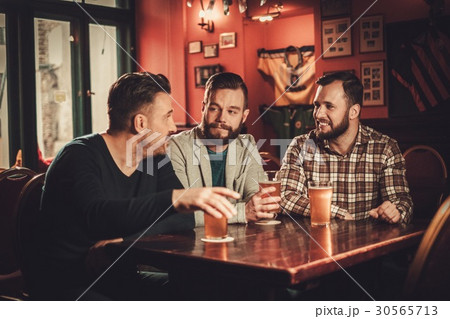 Cheerful old friends having fun and drinking draft Cheerful old friends having fun and drinking draft 30565713