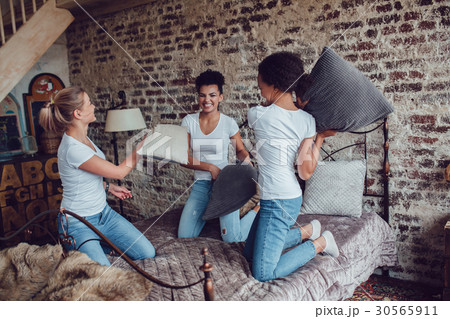 Attractive girls have fun and fight pillows on the Attractive girls have fun and fight pillows on the 30565911