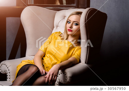 Studio shot of young and beautiful girl in yellow 30567950