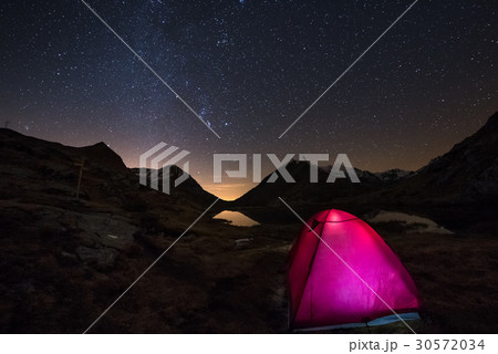 Camping under starry sky and Milky Way arc 30572034