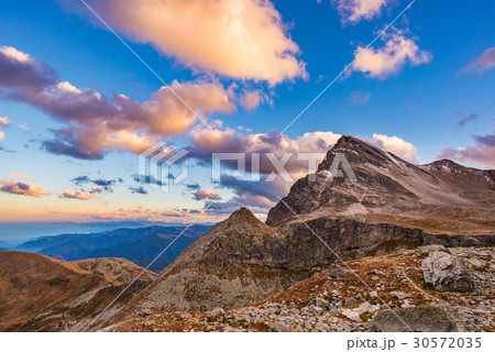 Last warm sunlight on alpine valley  30572035