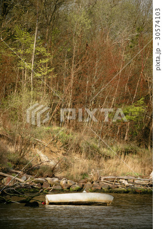 Stranded boat by a lake shore Stranded boat by a lake shore 30574103