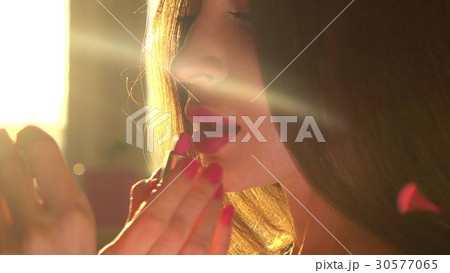 Beautiful young brunette woman using pink lipstick 30577065
