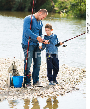 Man and little boy fishing Man and little boy fishing 30580396