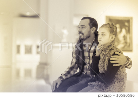 Father and small daughter looking artistic paintings Father and small daughter looking artistic paintings 30580586