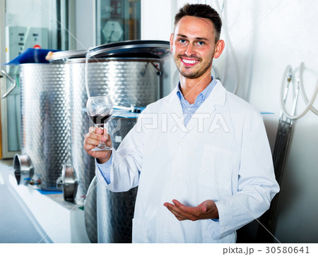 worker holding glass of wine worker holding glass of wine 30580641