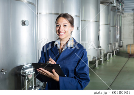 Smiling woman standing with cardboard 30580935