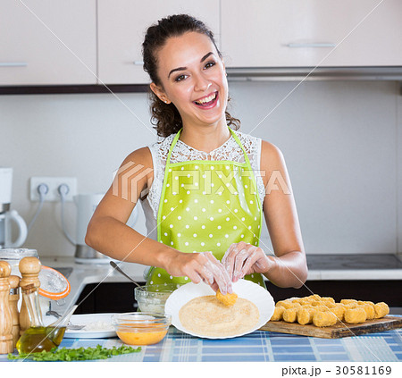 woman rolling filled croquettes 30581169