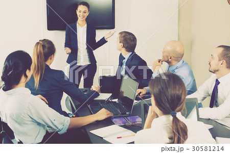 Female coworker making presentation during meeting Female coworker making presentation during meeting 30581214