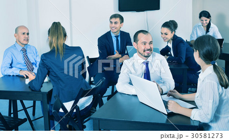 Coworkers working effectively on business project together Coworkers working effectively on business project together 30581273