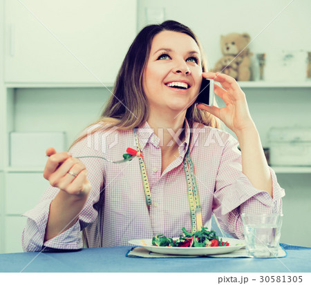 Girl eating salad 30581305