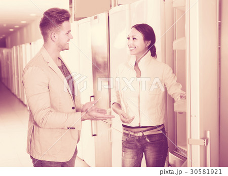 professional assistant in the shop sell a fridge to customer professional assistant in the shop sell a fridge to customer 30581921