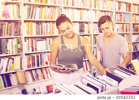 Smiling girl and boy taking new books 30582202