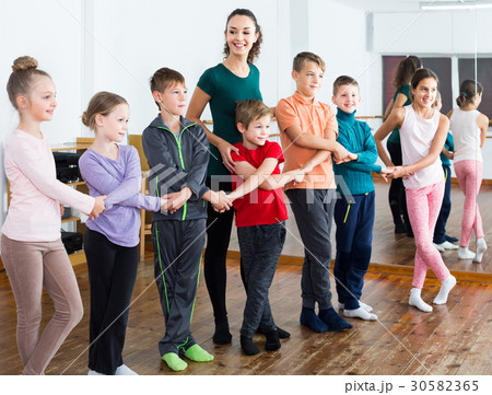 children studying folk style dance in class children studying folk style dance in class 30582365