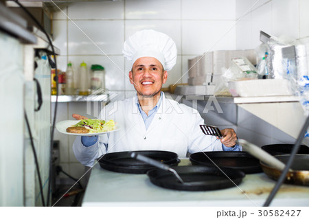 man with pans with kebab plate man with pans with kebab plate 30582427