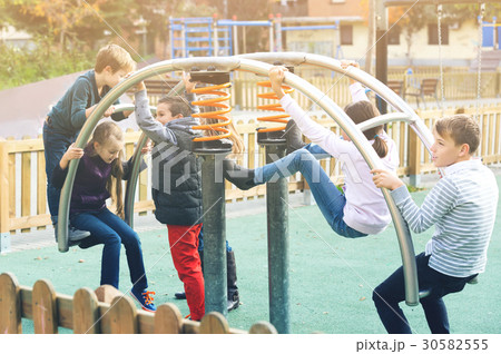 Children playing on swing 30582555