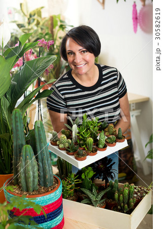 Woman holding a tray with cactuses 30582619