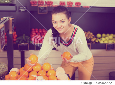 Girl deciding on fruits 30582772