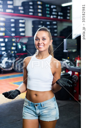 woman standing in car workshop indoors woman standing in car workshop indoors 30582981