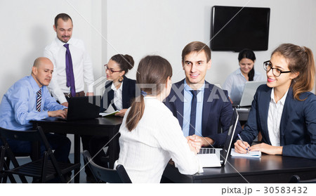 People working productively on business project together People working productively on business project together 30583432
