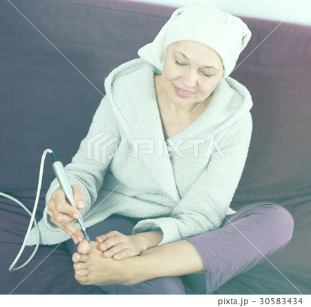Woman doing pedicure Woman doing pedicure 30583434