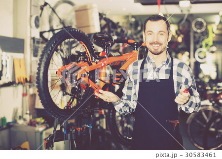 Man working on master mechanic assembling bicycle equipment Man working on master mechanic assembling bicycle equipment 30583461