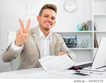 Successful man working showing victory gesture Successful man working showing victory gesture 30583575