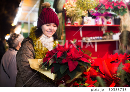 Cheerful teen girl chooses floral decorations Cheerful teen girl chooses floral decorations 30583753