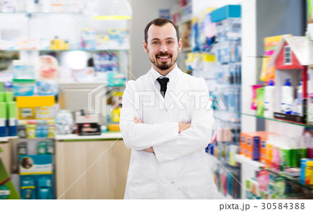 Glad male pharmacist suggesting useful drug Glad male pharmacist suggesting useful drug 30584388