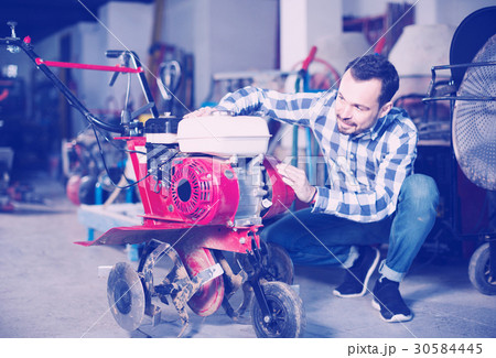 Person is starting to work with plough Person is starting to work with plough 30584445