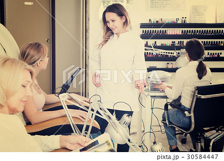 Woman doing nails displaying her workplace 30584447