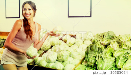 Positive woman shopping fresh green lettuce 30585024