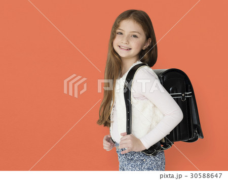 Young freckled girl carrying a backpack smiling portrait 30588647
