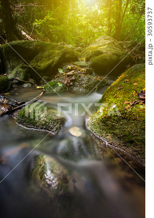water fall flow through the curve rock in Thailand water fall flow through the curve rock in Thailand 30593737